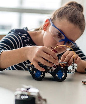 Student putting together a model car - Cambridge Engineering Summer School